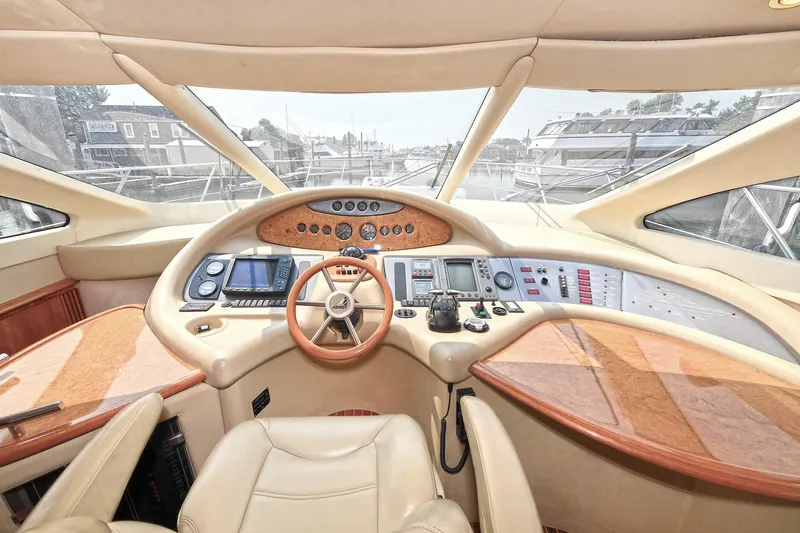  Yacht Photos Pics Luxurious 2003 Azimut 62 yacht cockpit with modern navigation controls and leather seating.