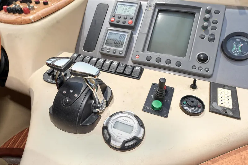  Yacht Photos Pics Control panel of a 2003 Azimut 62 yacht with navigation instruments and throttle controls.