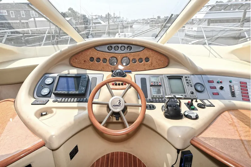  Yacht Photos Pics Cockpit of a 2003 Azimut 62 yacht with navigation instruments and steering wheel.