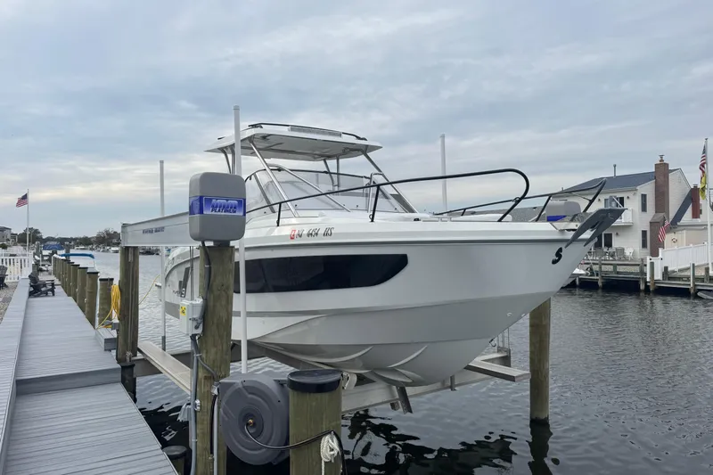  Yacht Photos Pics 2024 Beneteau Flyer 9 SUNdeck boat docked at marina, overcast sky.