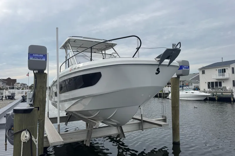  Yacht Photos Pics 2024 Beneteau Flyer 9 SUNdeck boat docked at marina, overcast sky.