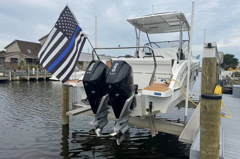  Yacht Photos Pics 2024 Beneteau Flyer 9 SUNdeck docked with dual outboard engines and flag.