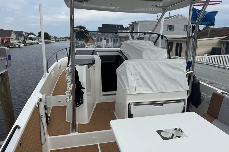  Yacht Photos Pics 2024 Beneteau Flyer 9 SUNdeck boat docked in a residential canal setting.