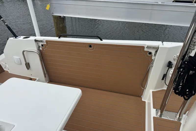  Yacht Photos Pics 2024 Beneteau Flyer 9 SUNdeck boat interior with brown deck and white table.