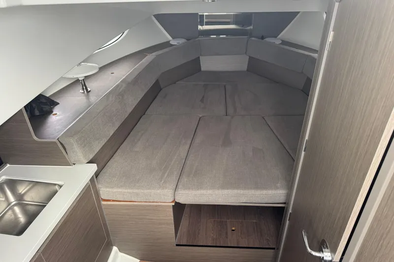  Yacht Photos Pics 2024 Beneteau Flyer 9 SUNdeck cabin interior with gray seating and compact sink.