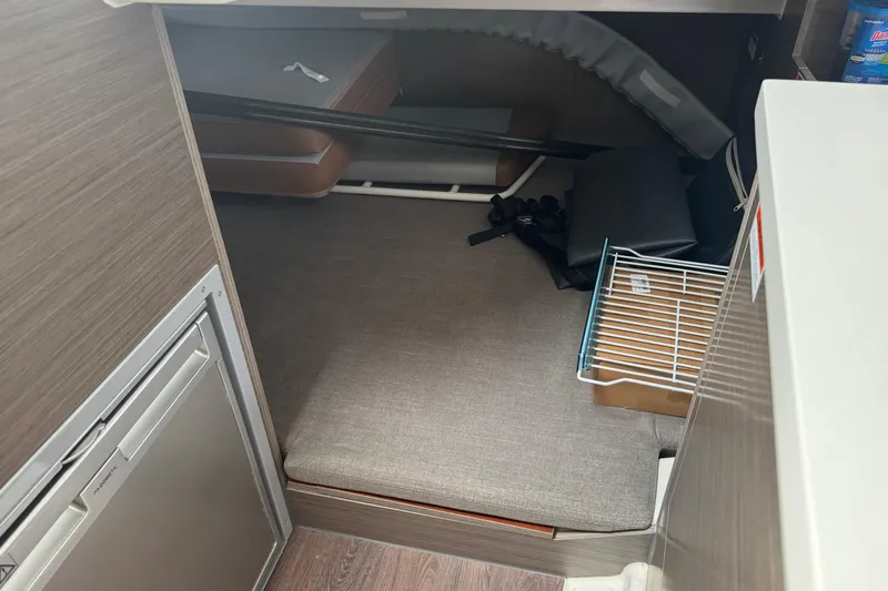  Yacht Photos Pics 2024 Beneteau Flyer 9 SUNdeck interior cabin with storage and seating area.