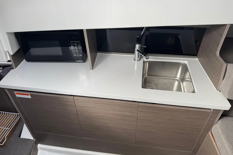  Yacht Photos Pics 2024 Beneteau Flyer 9 SUNdeck kitchenette with sink and microwave, modern design.