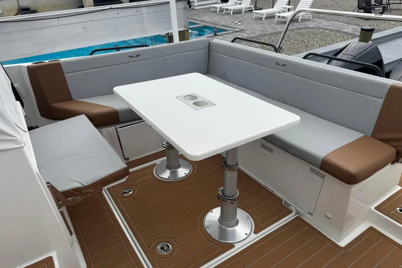  Yacht Photos Pics 2024 Beneteau Flyer 9 SUNdeck interior with cushioned seating and table.