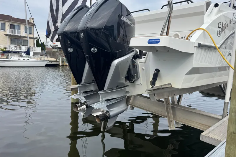  Yacht Photos Pics 2024 Beneteau Flyer 9 SUNdeck with dual Mercury outboard engines docked by waterfront homes.
