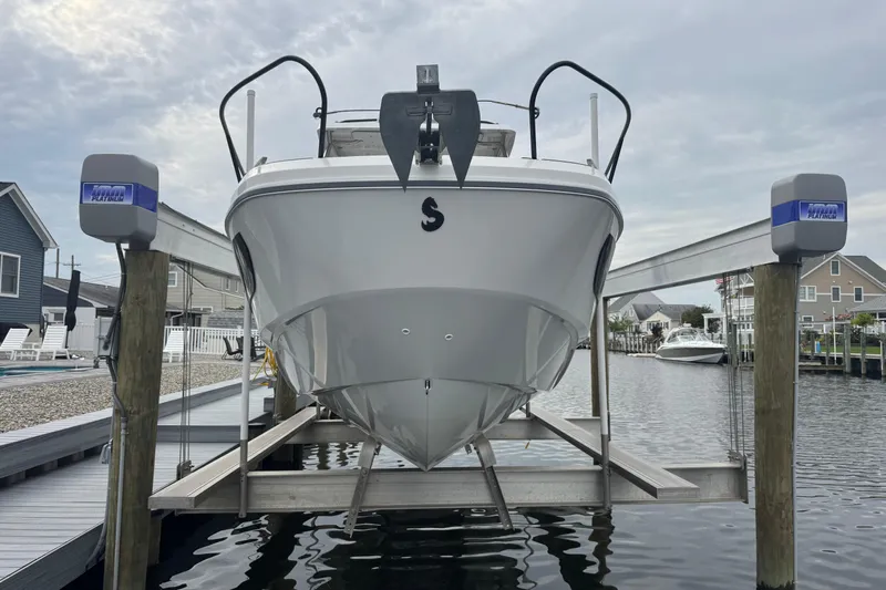  Yacht Photos Pics 2024 Beneteau Flyer 9 SUNdeck boat on lift at marina, front view.