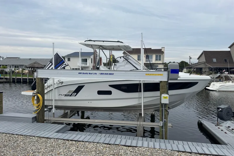 Yacht Photos Pics 2024 Beneteau Flyer 9 SUNdeck boat docked at a marina, side view.