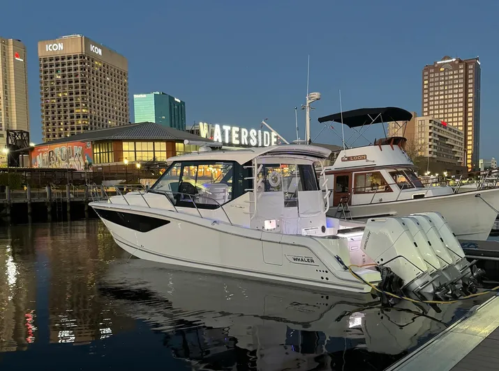  Yacht Photos Pics 2024 Boston Whaler 405 Conquest docked at a city marina during evening.