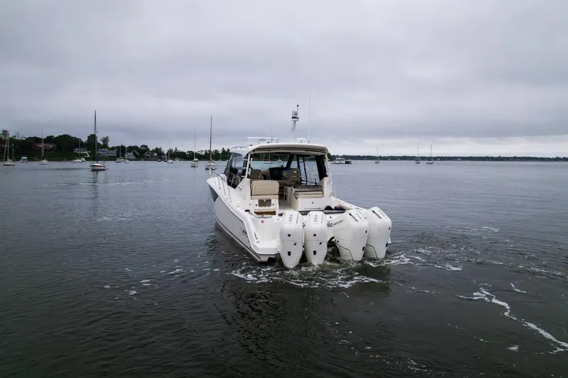  Yacht Photos Pics 2024 Boston Whaler 405 Conquest boat on calm water, rear view with multiple outboard engines.