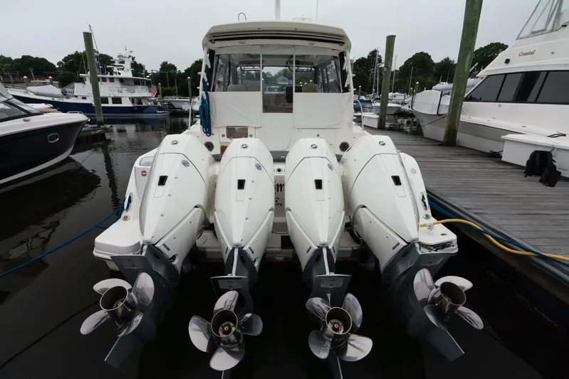  Yacht Photos Pics 2024 Boston Whaler 405 Conquest with four powerful outboard engines docked at marina.