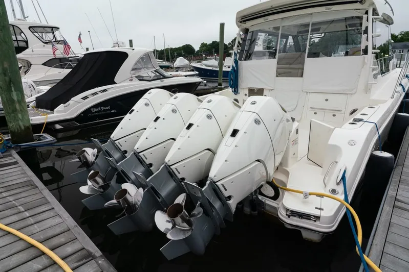  Yacht Photos Pics 2024 Boston Whaler 405 Conquest with four powerful outboard engines docked at marina.