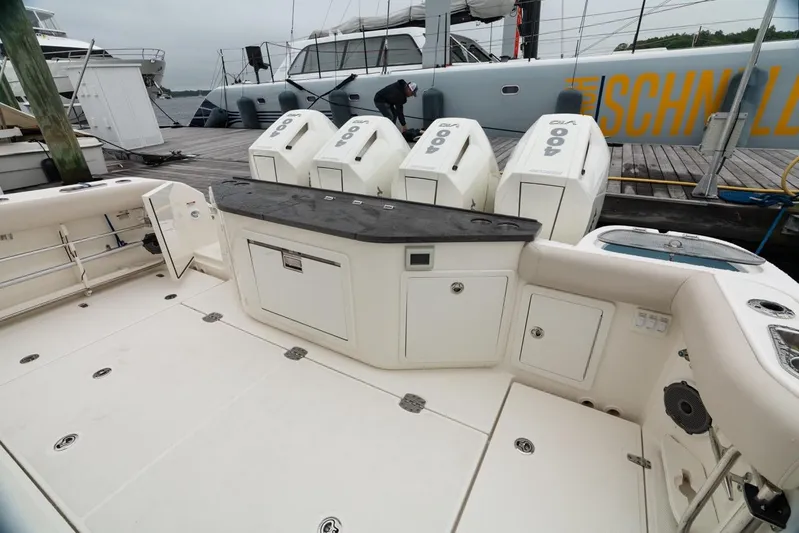  Yacht Photos Pics 2024 Boston Whaler 405 Conquest boat deck with quad 400 engines at dock.