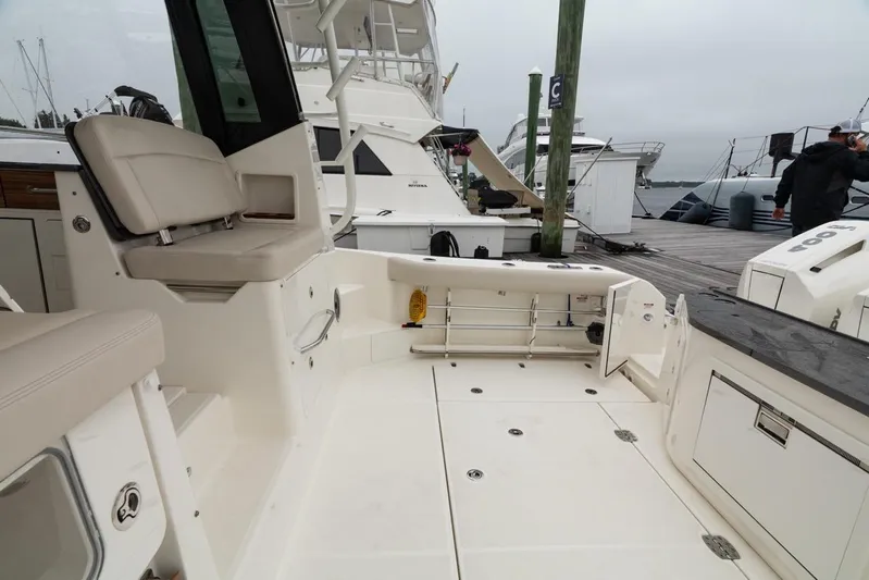  Yacht Photos Pics 2024 Boston Whaler 405 Conquest boat interior with seating and storage, docked at marina.