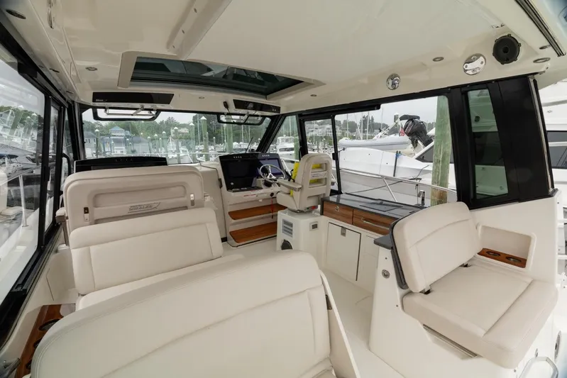  Yacht Photos Pics 2024 Boston Whaler 405 Conquest interior with luxurious seating and modern helm.