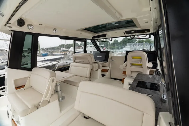  Yacht Photos Pics 2024 Boston Whaler 405 Conquest interior with luxurious seating and advanced navigation systems.