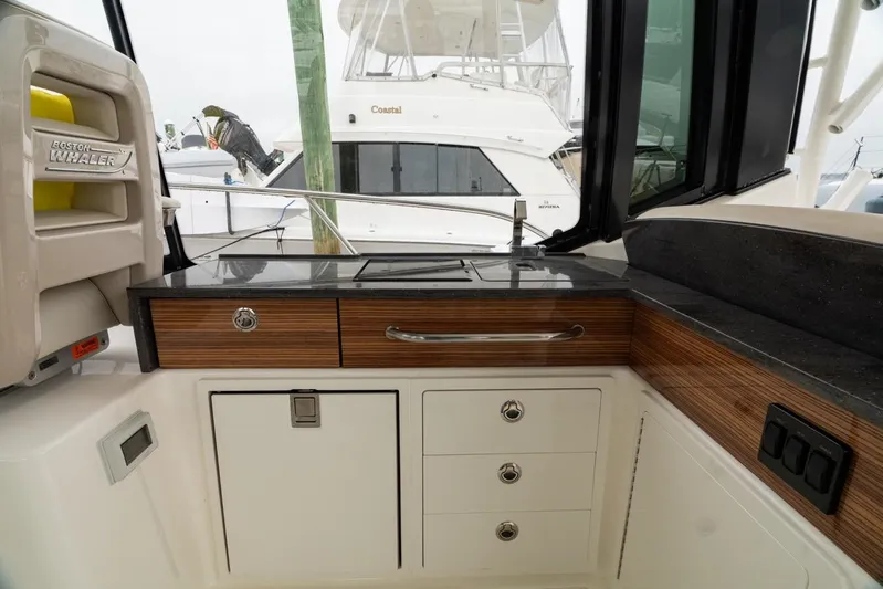  Yacht Photos Pics 2024 Boston Whaler 405 Conquest interior with sleek cabinetry and countertop.