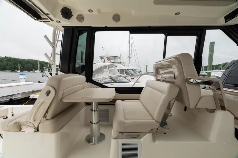  Yacht Photos Pics 2024 Boston Whaler 405 Conquest interior with beige seating and table, docked at marina.