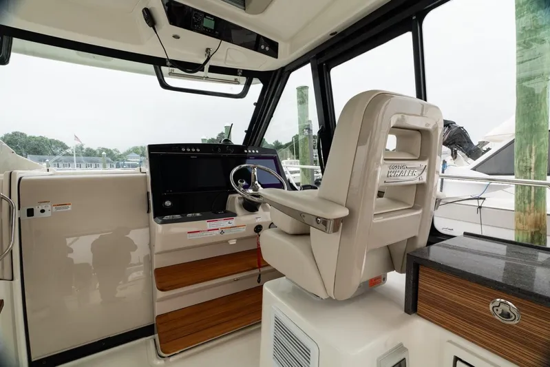  Yacht Photos Pics 2024 Boston Whaler 405 Conquest helm with modern controls and comfortable captain's chair.