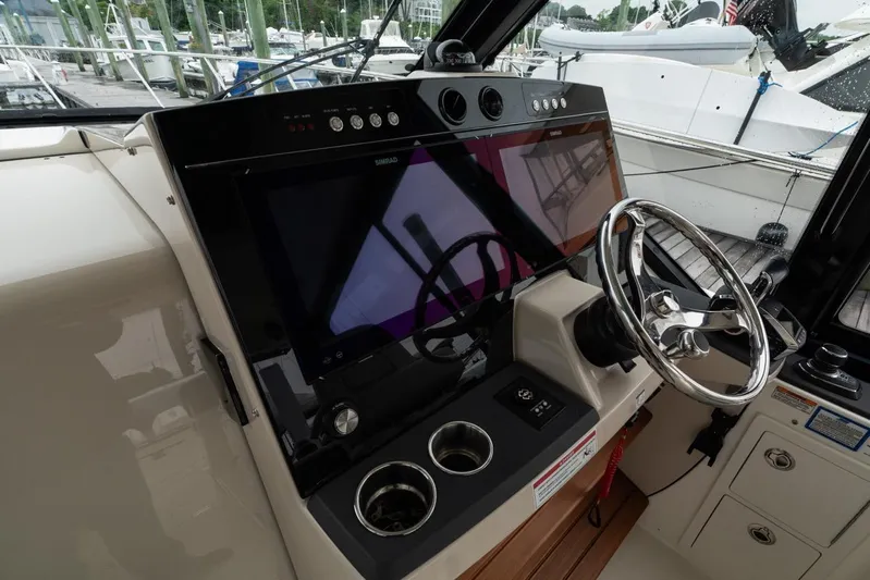  Yacht Photos Pics Helm of 2024 Boston Whaler 405 Conquest with modern controls and steering wheel.