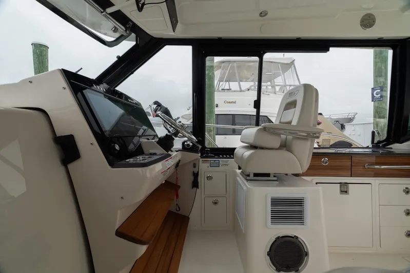  Yacht Photos Pics 2024 Boston Whaler 405 Conquest helm with modern controls and comfortable seating.
