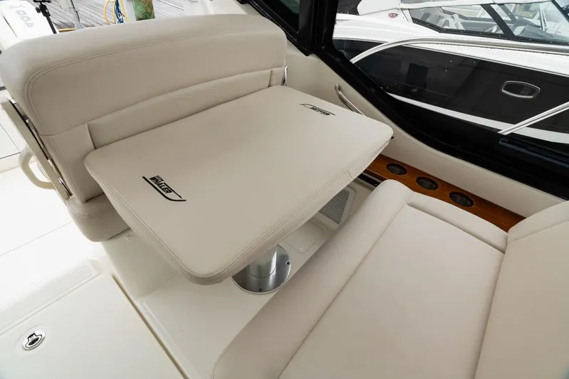  Yacht Photos Pics 2024 Boston Whaler 405 Conquest interior seating with table, showcasing luxury and comfort.