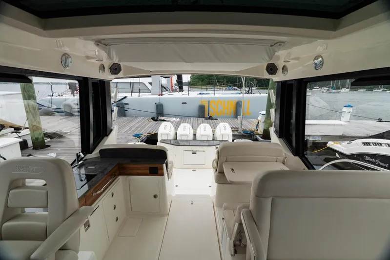  Yacht Photos Pics Interior view of 2024 Boston Whaler 405 Conquest yacht at dock, featuring luxurious seating.