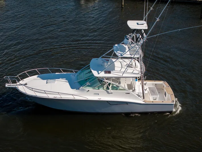 Ryfly Yacht Photos Pics 2004 Cabo 40 Express yacht cruising on calm waters.