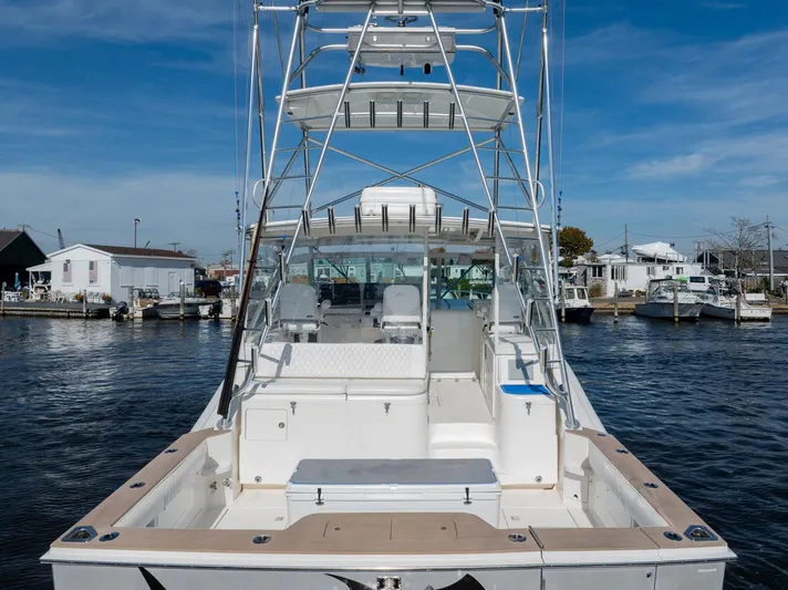 Ryfly Yacht Photos Pics 2004 Cabo 40 Express boat docked at marina, featuring spacious deck and tower.