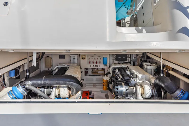 Ryfly Yacht Photos Pics Engine compartment of 2004 Cabo 40 Express boat, showcasing dual engines and mechanical components.