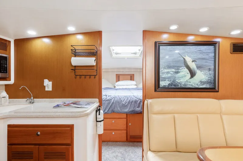 Ryfly Yacht Photos Pics Interior of 2004 Cabo 40 Express yacht with cozy seating and elegant wood finishes.