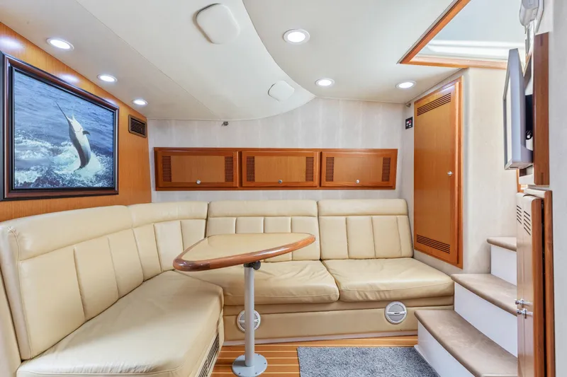 Ryfly Yacht Photos Pics Interior of 2004 Cabo 40 Express yacht with beige seating and wooden accents.