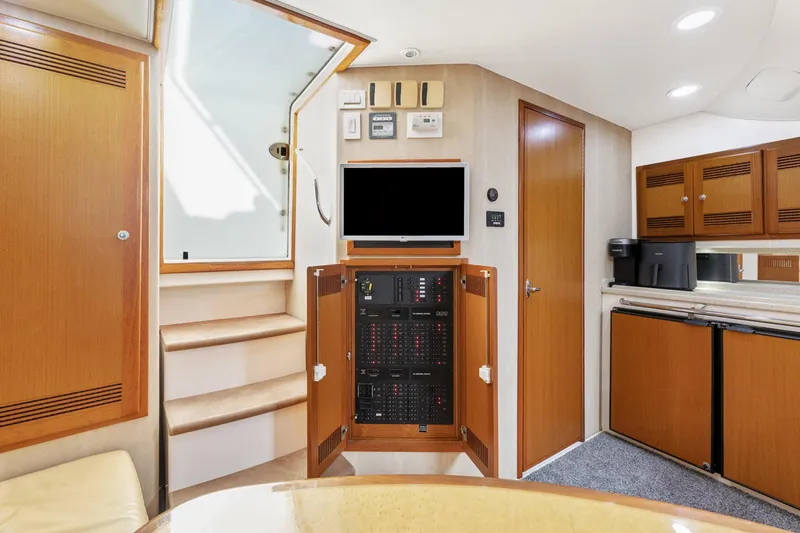 Ryfly Yacht Photos Pics Interior of 2004 Cabo 40 Express yacht with wooden cabinetry and modern amenities.
