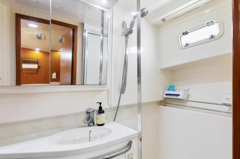 Ryfly Yacht Photos Pics Luxurious bathroom in 2004 Cabo 40 Express yacht with modern fixtures and sleek design.