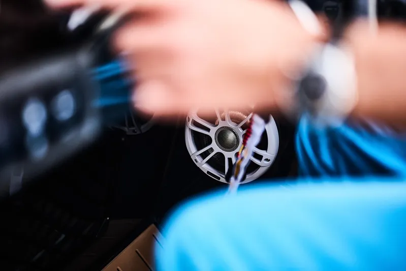  Yacht Photos Pics Close-up of a Skamander Sorrento 2025 interior with blurred motion, focusing on steering wheel.