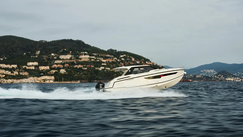  Yacht Photos Pics 2025 Skamander Sorrento boat cruising on open water with scenic hillside backdrop.