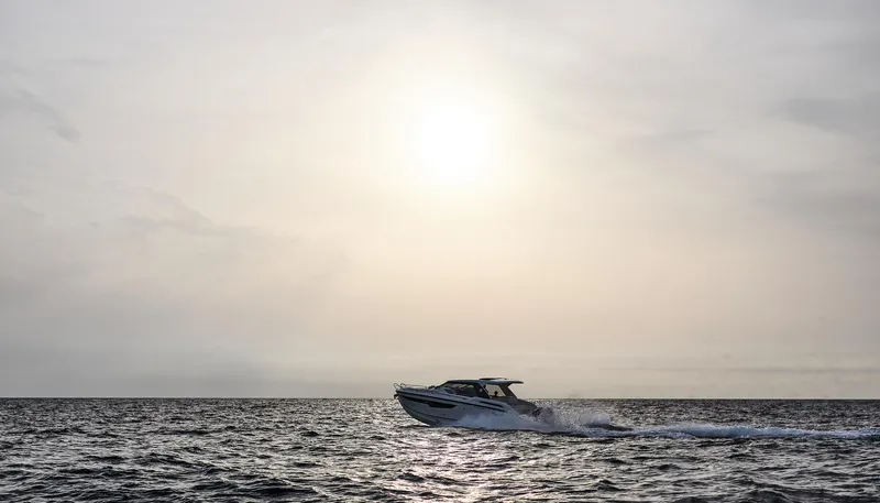  Yacht Photos Pics 2025 Skamander Sorrento boat cruising on open sea at sunset.