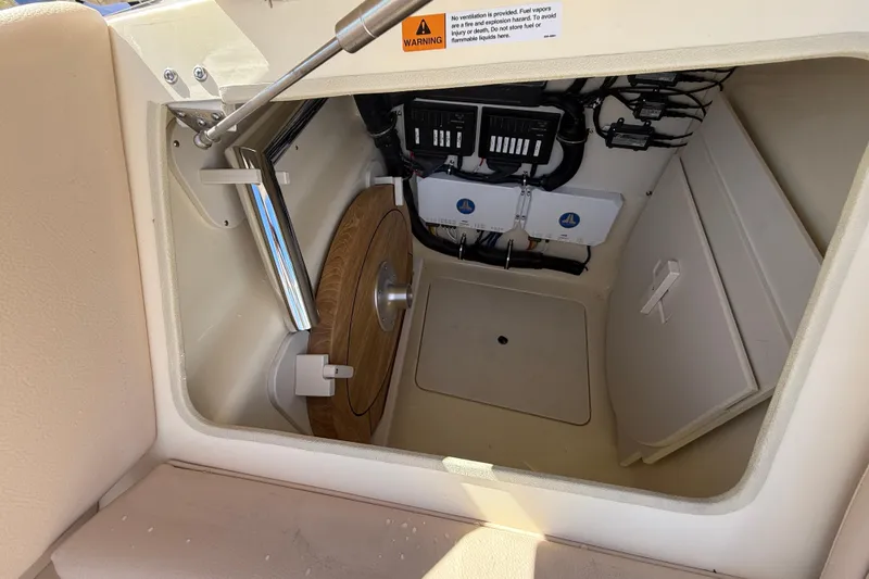  Yacht Photos Pics 2026 Chris-Craft Launch 31 GT storage compartment with electrical components and wooden panel.