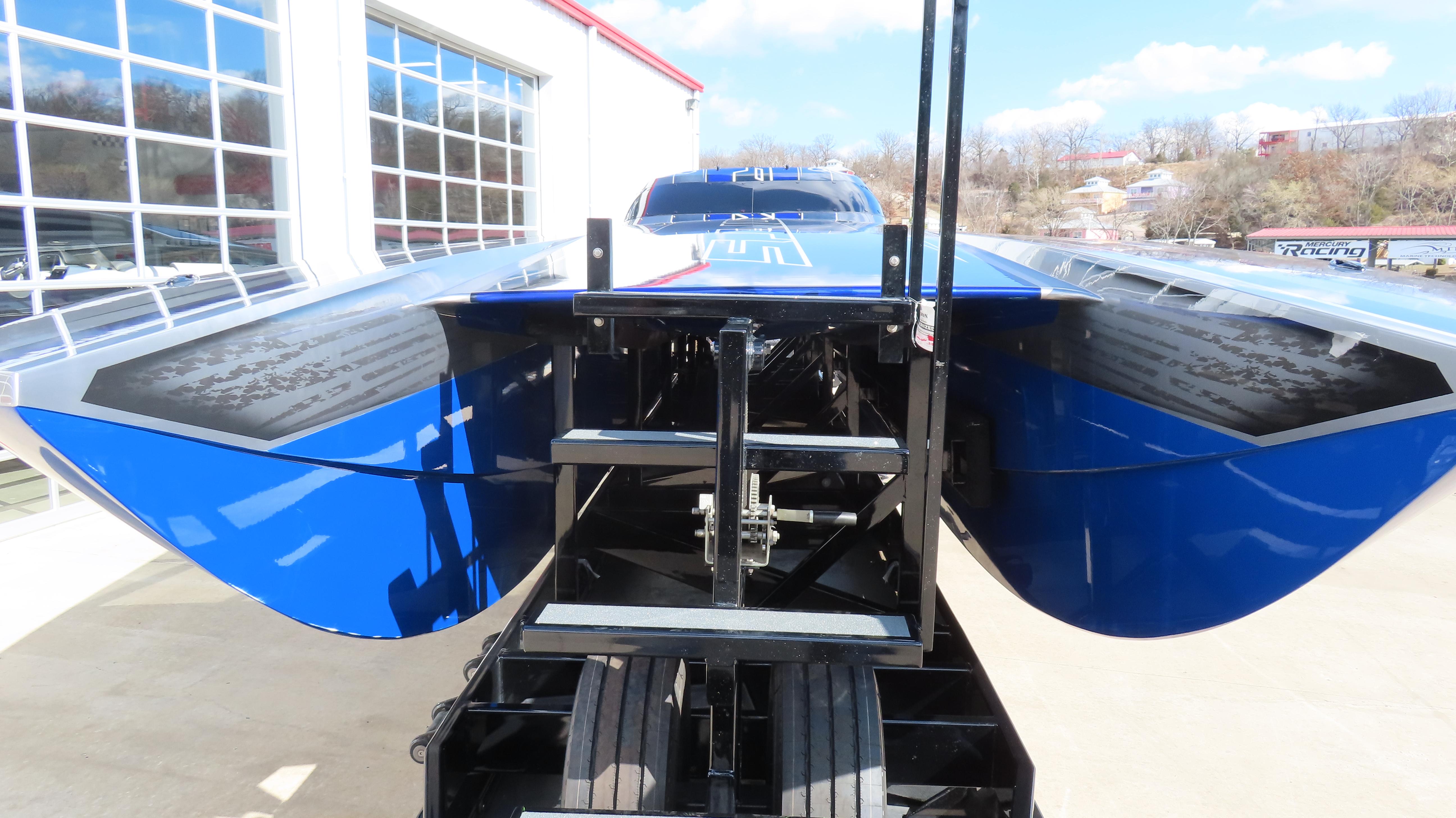 2020 Outerlimits 46SC powerboat on trailer, blue hull, parked outdoors.