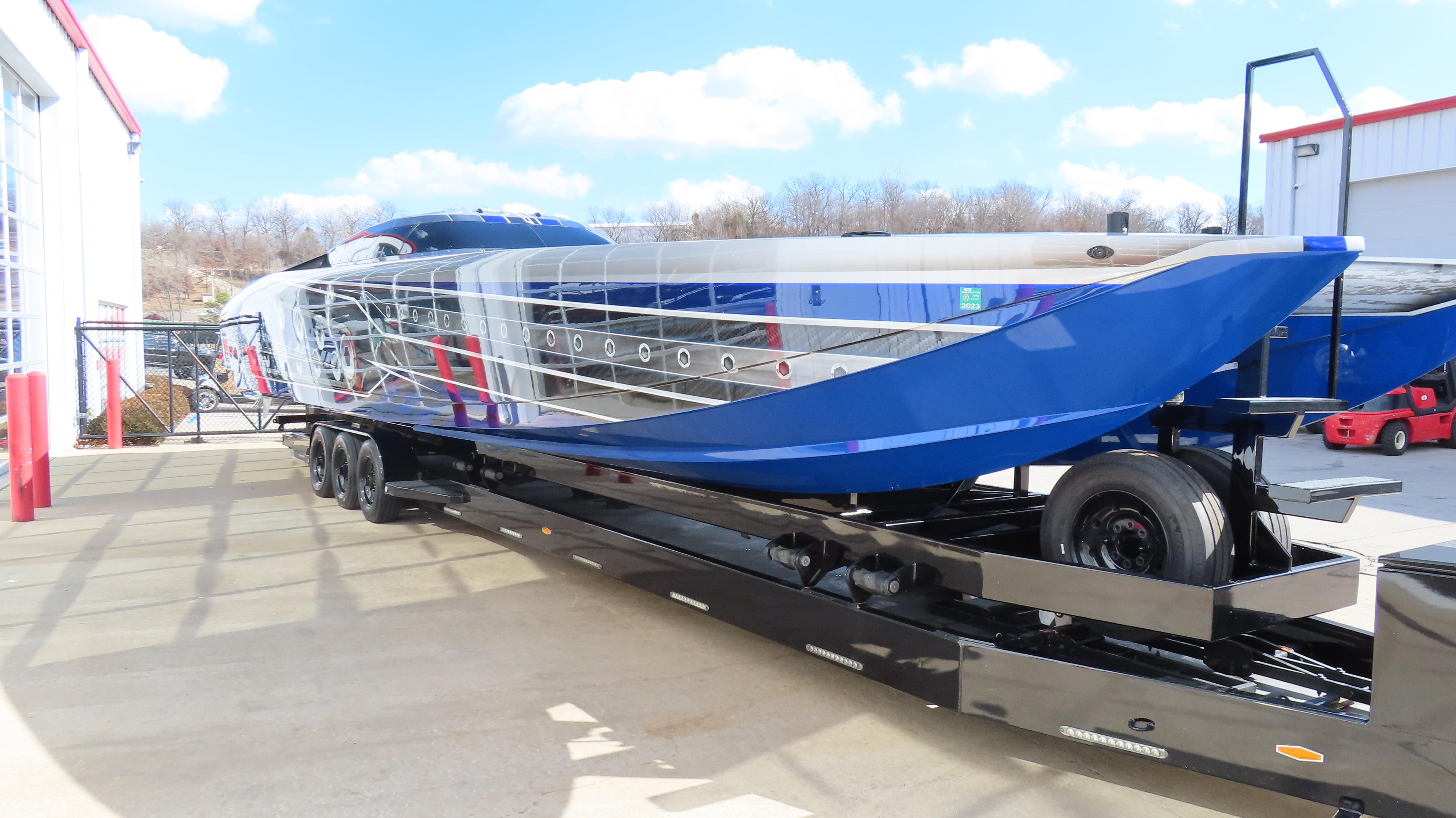 2020 Outerlimits 46SC powerboat on a trailer, blue and silver exterior.