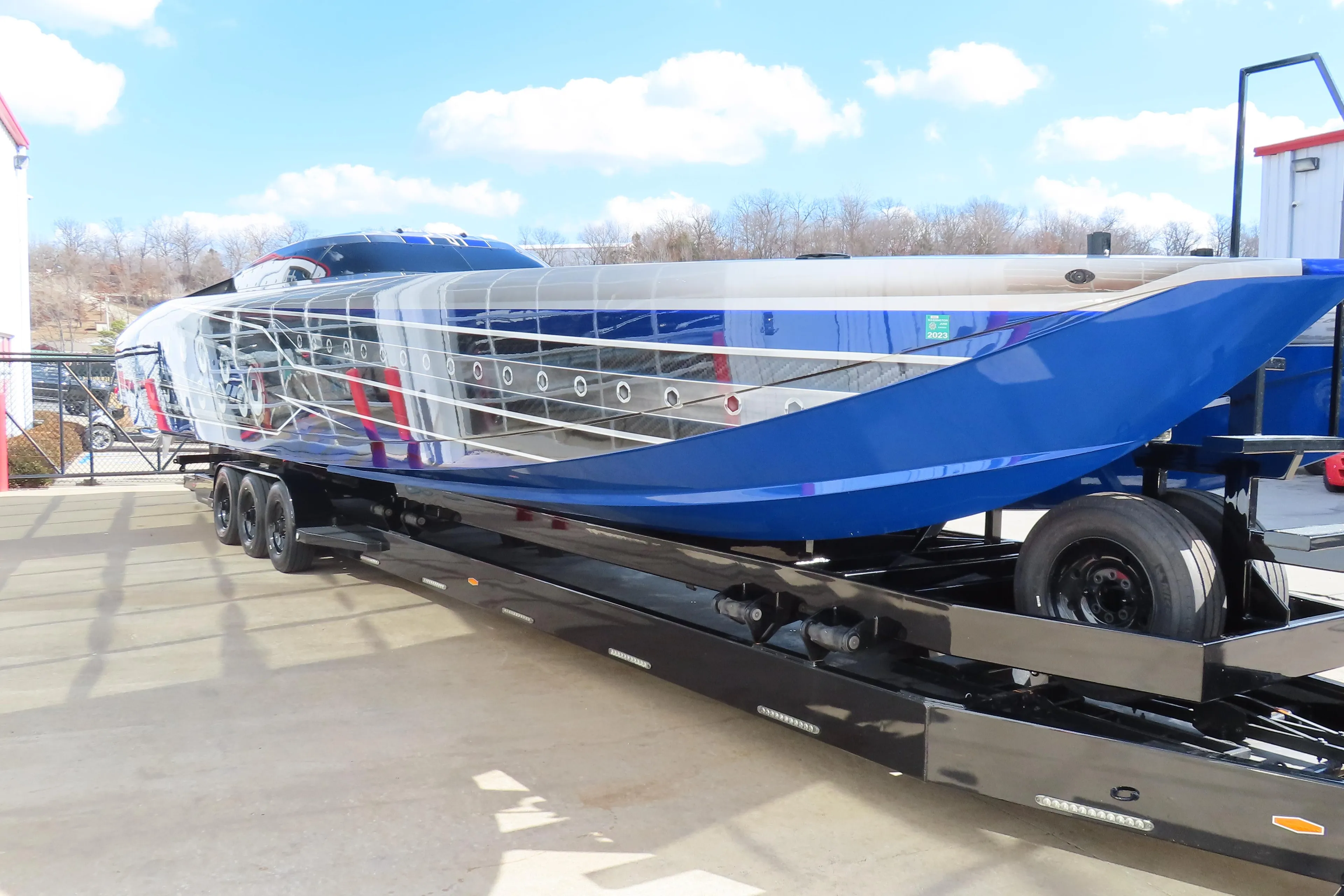 2020 Outerlimits 46SC powerboat on a trailer, blue and silver exterior.