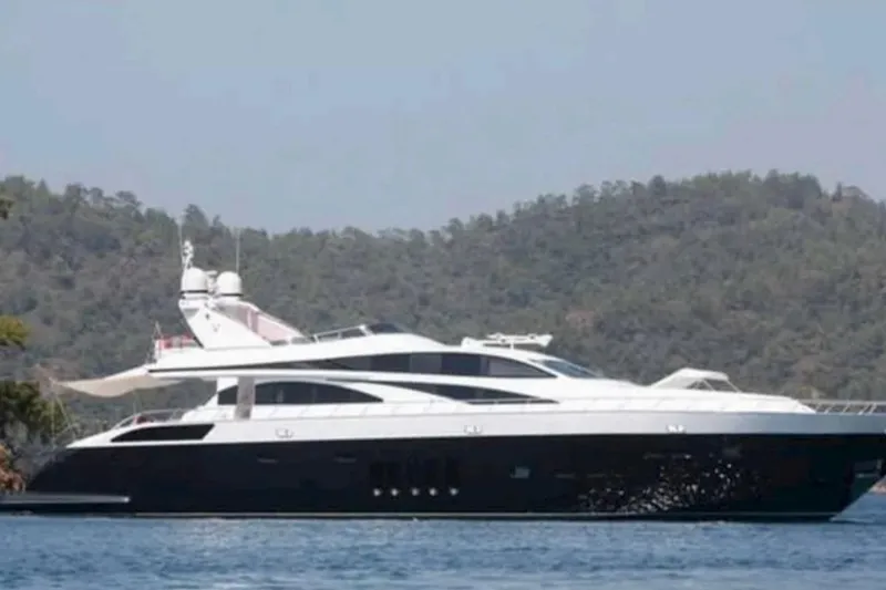  Yacht Photos Pics Luxurious 2008 Leopard 105 yacht cruising on serene waters with forested hills in the background.