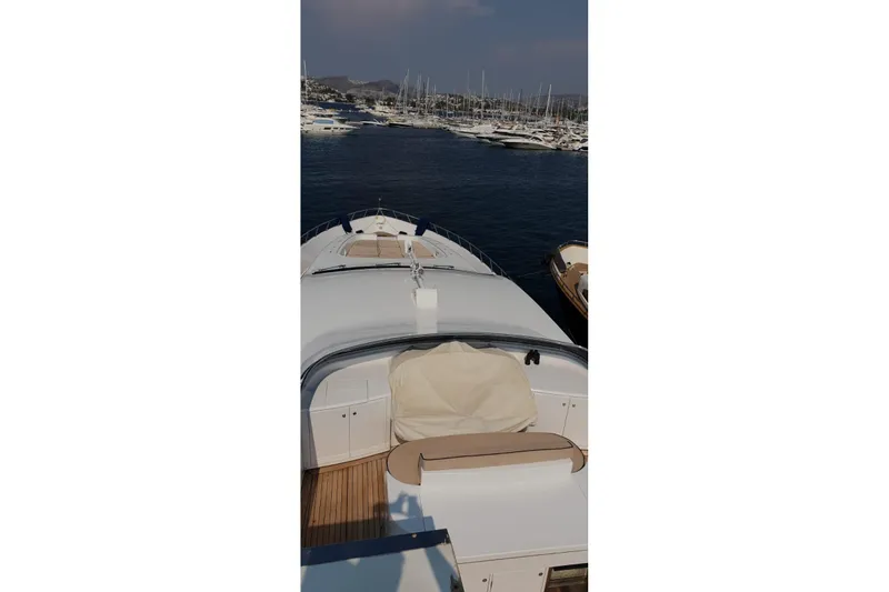  Yacht Photos Pics Luxury Leopard 105 yacht from 2008 docked in a marina, surrounded by boats.