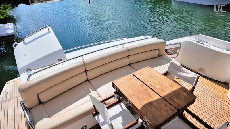 Phantom Yacht Photos Pics Luxurious Sunseeker Manhattan 63 yacht deck with seating and wooden table, 2011 model.