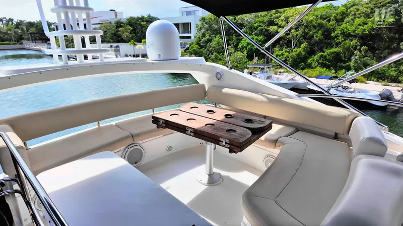 Phantom Yacht Photos Pics Luxurious Sunseeker Manhattan 63 yacht deck with seating, table, and scenic waterfront view.