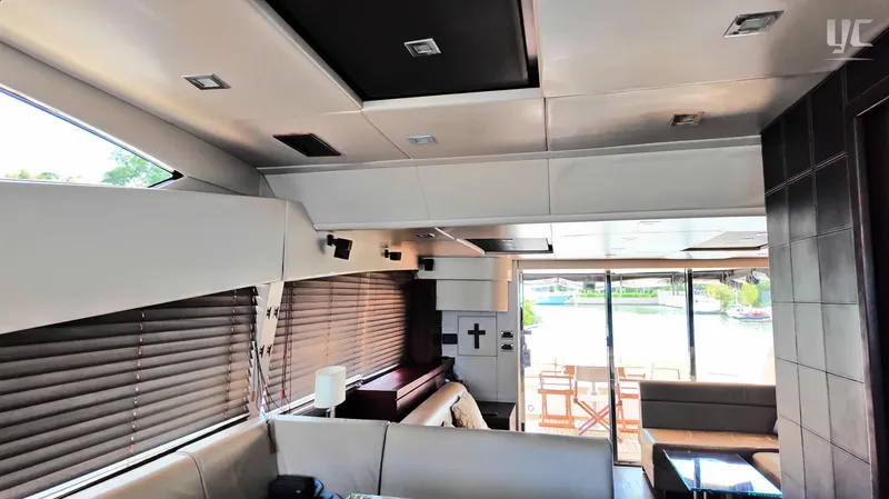 Phantom Yacht Photos Pics Luxurious interior of 2011 Sunseeker Manhattan 63 yacht with modern furnishings and large windows.