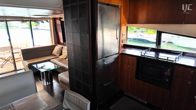 Phantom Yacht Photos Pics Luxurious interior of 2011 Sunseeker Manhattan 63 yacht with modern kitchen and seating area.